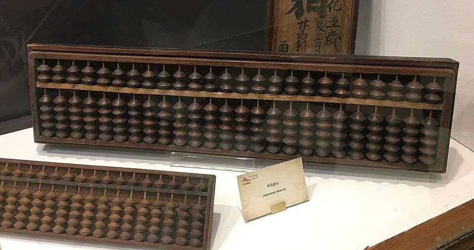 Two historical Japanese abacuses displayed in a museum.